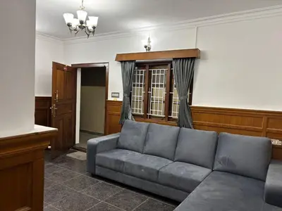 a living room with a couch in a room at Travel & Stay in Ooty