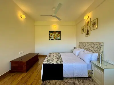 a bedroom with a bed and a dresser in it at Jade Pearl Kotagiri in Kotagiri