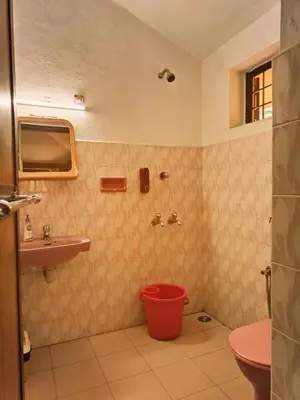 a bathroom with a toilet and a sink at Bough'n Villa 1B - Balcony room in Kozhikode
