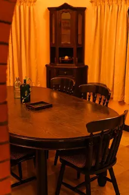 a dining room table with chairs and a cabinet at Bough'n Villa 1B - Balcony room in Kozhikode