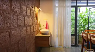 a bathroom with a sink on a counter and a window at Solace Villa 2BHK AC in Kakkayam