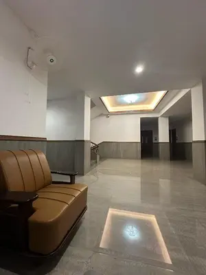 a waiting room with a couch in the middle at Bloomax Residency in Malappuram