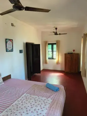 a bedroom with a bed and a ceiling at Casa Shanti in Kannur