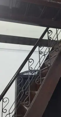 a stair case with a metal railing on top at Casa Shanti in Kannur