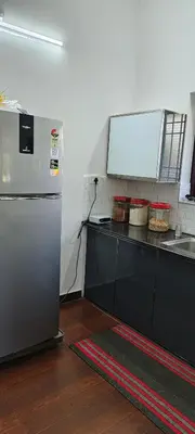a kitchen with a counter and a refrigerator at joys villa self service villa in Cherai Beach
