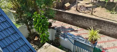 a set of stairs with a tree and a fence at joys villa self service villa in Cherai Beach