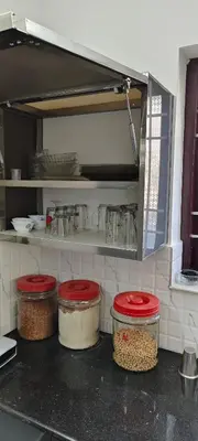 a kitchen with four jars of food on a counter at joys villa self service villa in Cherai Beach