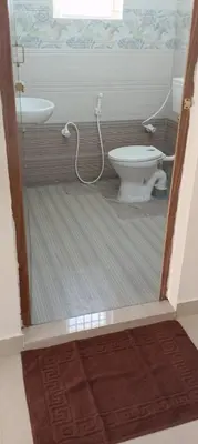 a bathroom with a toilet and a sink at Sri Annapoorna Luxury Apartment - Serviced Apartment in Coimbatore