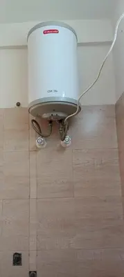 a water heater in a room with a wooden floor at Sri Annapoorna Luxury Apartment - Serviced Apartment in Coimbatore