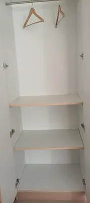 a white closet with white shelves in a room at Sri Annapoorna Luxury Apartment - Serviced Apartment in Coimbatore
