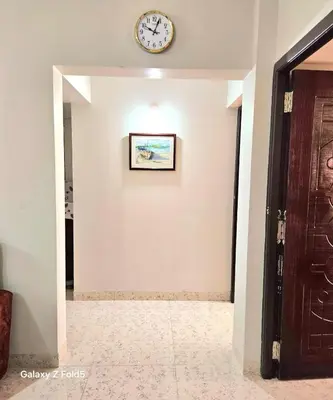 a clock on a wall in a hallway at Urban Suites in Coimbatore