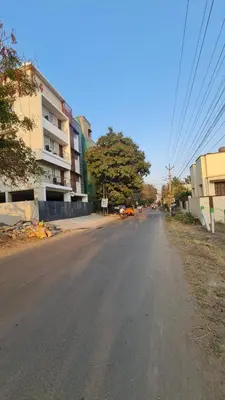 an empty street in a city with a building at Urban Suites in Coimbatore