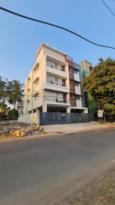 a tall building on the side of a street at Urban Suites in Coimbatore