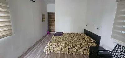 a bedroom with a bed in the corner of a room at Nila Organica Farm Stay in Palakkad
