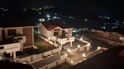a view of a city at night with lights at Villa Bella in Ooty
