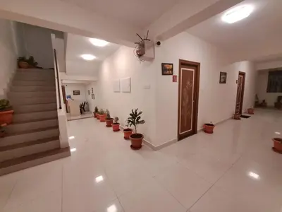 a hallway with potted plants and stairs in a building at Labony House in Kodaikānāl