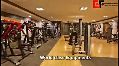 a gym with lots of cardio equipment in a building at Woods inn in Coimbatore