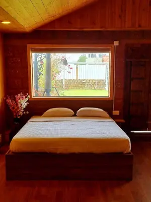 a bed in a room with a window at Woods inn in Coimbatore