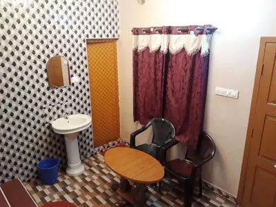 a small bathroom with a table and a sink at RAOJI HomeStay in Vālpārai