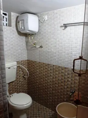 a bathroom with a toilet and a sink at RAOJI HomeStay in Vālpārai
