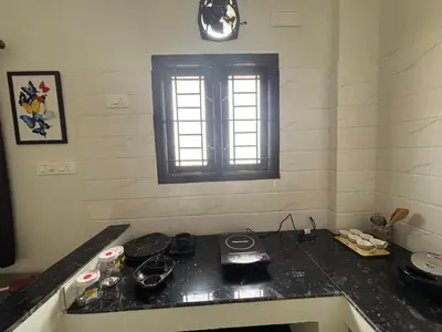 a kitchen with a stove and a window in it at TVK Grands 7 - Premium Two Bedroom Apartment in Coimbatore