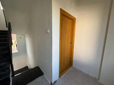a hallway with a wooden door on a wall at TVK Grands 7 - Premium Two Bedroom Apartment in Coimbatore