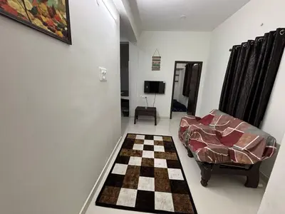 a living room with a couch and a checkerboard floor at TVK Grands 7 - Premium Two Bedroom Apartment in Coimbatore