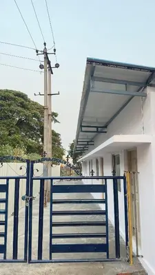 a blue gate in front of a building at StayIn-SGH near Mysore palace in Mysore