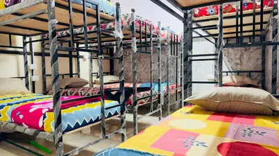 a room with four bunk beds in a room at StayIn-SGH near Mysore palace in Mysore