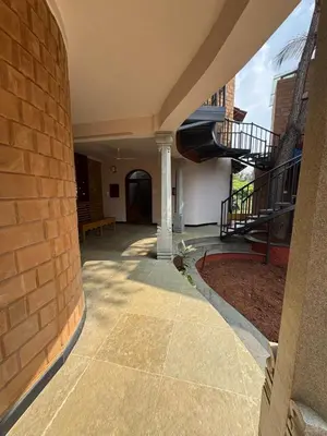 a hallway of a building with a brick wall at EcoMinimalist Home by the River in Seringapatam
