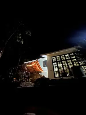 a building with a ladder in front of it at night at Hazel and Oak in Vythiri