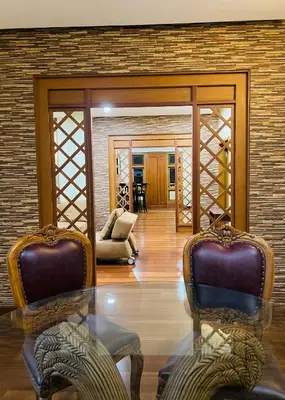 a living room with two chairs and a glass table at Yemcee Rivera Homestay in Green Island