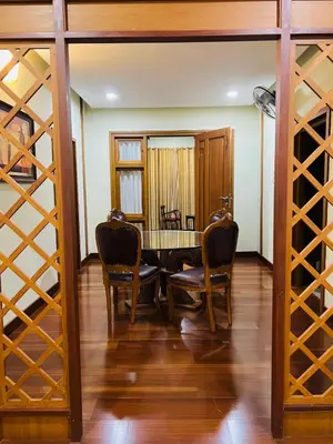 a dining room with a table and chairs and wine racks at Yemcee Rivera Homestay in Green Island