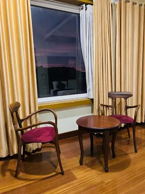 two chairs and a table in front of a window at Yemcee Rivera Homestay in Green Island