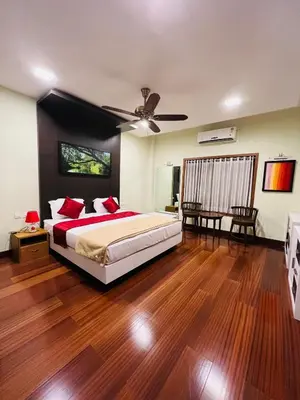 a bedroom with a bed and a ceiling fan at Yemcee Rivera Homestay in Green Island