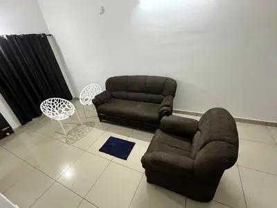 a living room with a couch and a chair at Sunrise Boutique Villa in Kozhikode