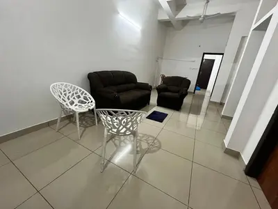 a living room with two chairs and a couch at Sunrise Boutique Villa in Kozhikode