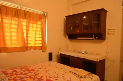 a bedroom with a bed and a sink and a window at 2BHK City View Calicut in Kozhikode