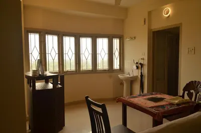 a dining room with a table and a table and chairs at 2BHK City View Calicut in Kozhikode