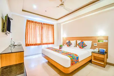 a bedroom with a large bed and a window at FabHotel Prime Royal Castle - Nr Coimbatore North Railway Station in Coimbatore