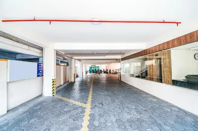 an empty hallway of a building with a yellow line on the floor at FabHotel Prime Royal Castle - Nr Coimbatore North Railway Station in Coimbatore