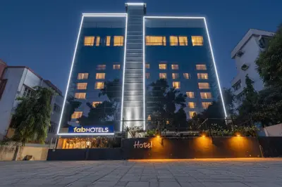 a tall blue building with lights in front of it at FabHotel Prime Royal Castle - Nr Coimbatore North Railway Station in Coimbatore