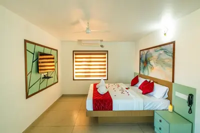 a bedroom with a bed and a window at Hotel Eden Palace in Trichūr