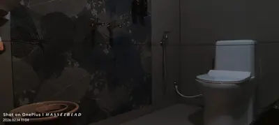 a bathroom with a toilet and a shower at Hotel Eden Palace in Trichūr