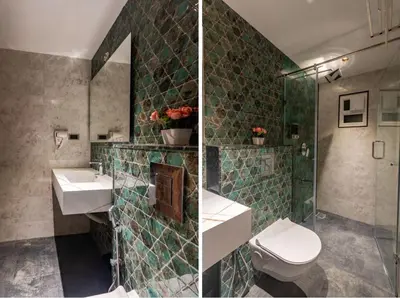 a bathroom with a toilet and a sink and a shower at Serenity Suites in Ooty