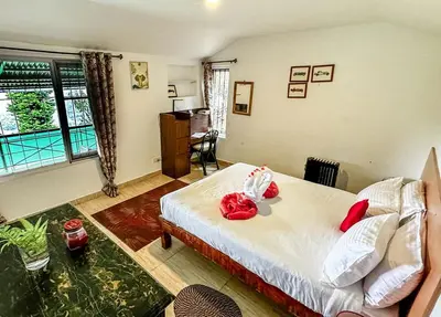 a bedroom with a bed with red roses on it at Manas Valley View bungalow by Xacro Xperiences in Kodaikānāl