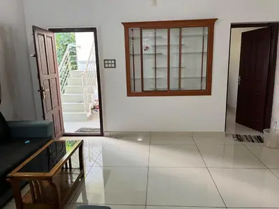 a living room with a couch and a window at Safari Homestay, Malayattoor in Kodanad