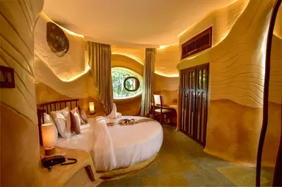 a bedroom with a large bed in a room at Toroland Munnar in Viripara