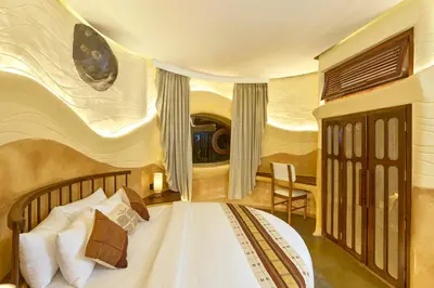 a bedroom with a bed with a rock wall at Toroland Munnar in Viripara