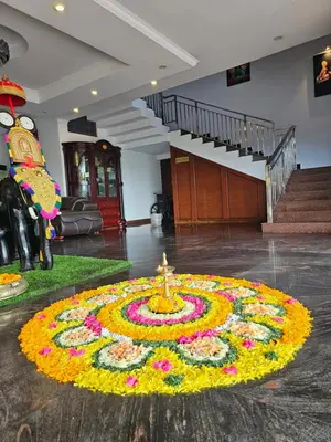 a room with a flower arrangement in the middle of a building at Hotel Chithrapuri in Parli